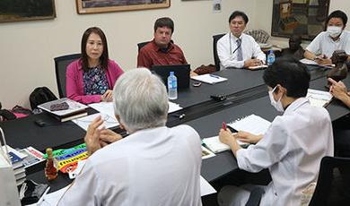 BSU and Japanese researchers sit at a conference table.